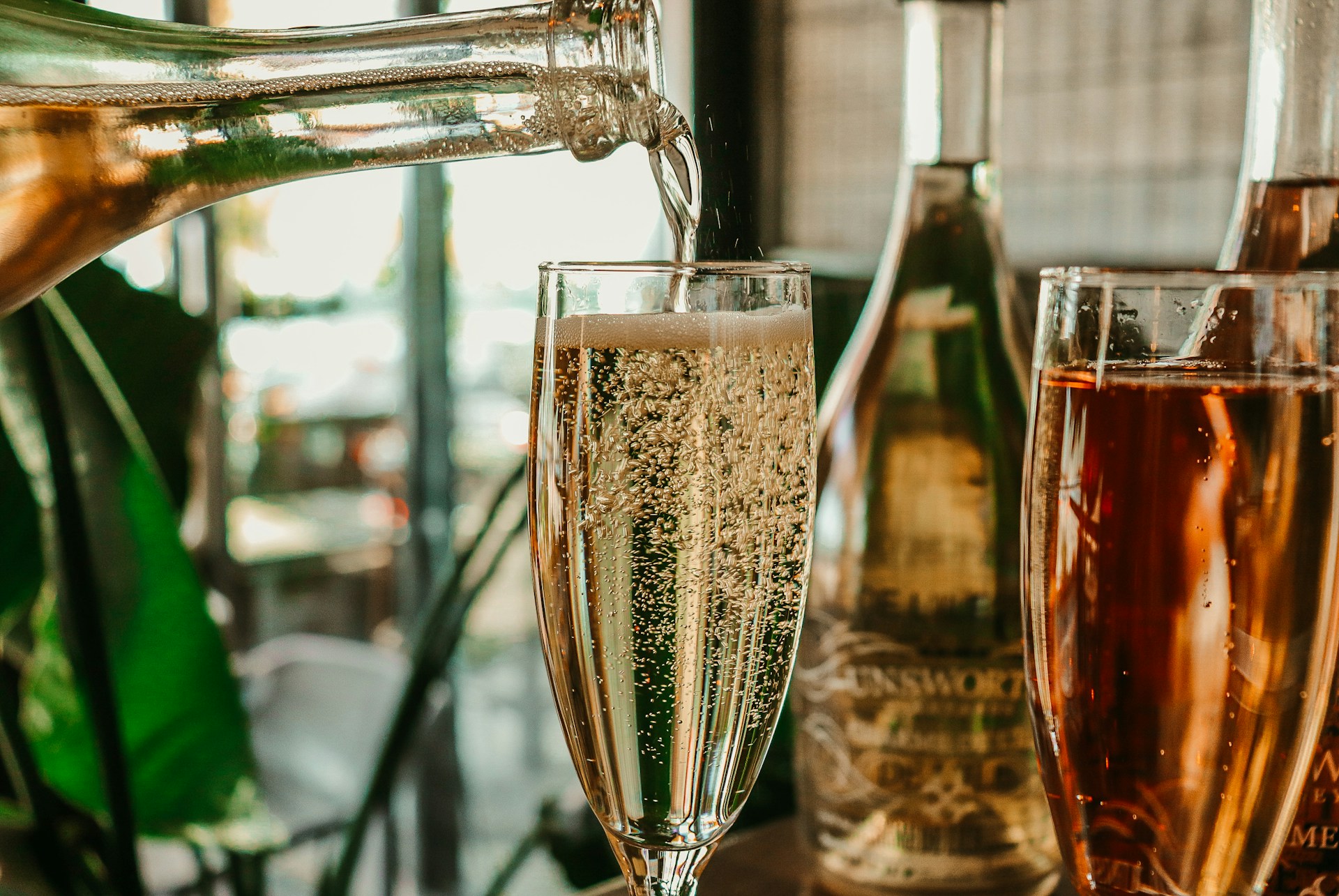 Sparkling drinks being poured at a table.